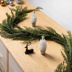 decorative holiday garland made from cedar on a cabinet with holiday decor