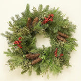 Christmas wreath with greenery, pinecones, and red berries on a white background