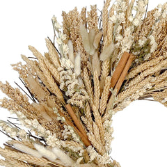 h potter dried wheat and grass wreath in natural beige and cream tones, featuring stalks of wheat, fluffy pampas grass, small white flowers, and two cinnamon sticks, shown against a plain white background.