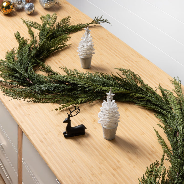 decorative holiday garland made from cedar on a cabinet with holiday decor