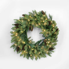 Christmas wreath with lights and pinecones on a white background