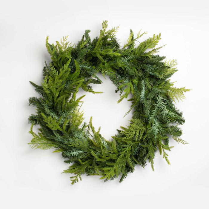 green faux cedar christmas wreath on a whitebackground