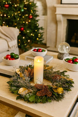 Christmas wreath table setting with a candle in the middle in a living room