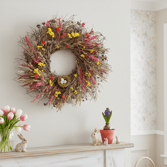 Spring decorative wreath, colorful dried botanicals and birds nest above a spring themed mantel