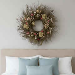 decorative spring botanical wreath, bright pink and green florals above a bed